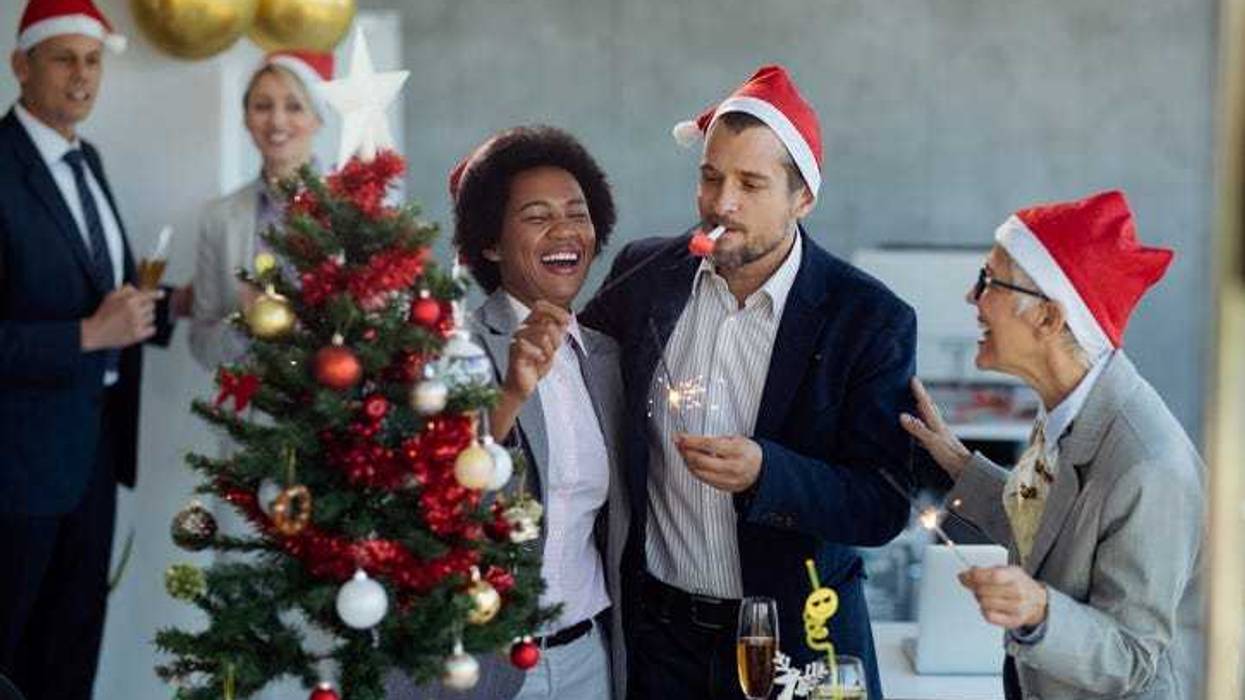 Group of happy business people celebrating Christmas and having fun on office party.