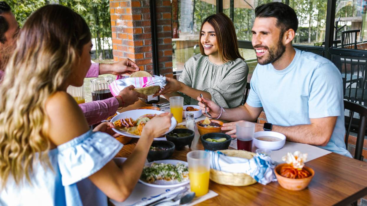 Group of latin friends eating mexican food in the restaurant terrace in Mexico Latin America