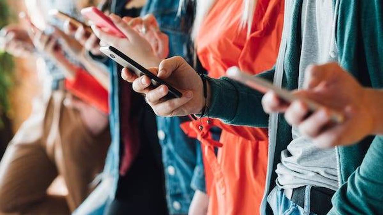 Group of people looking at their cell phones