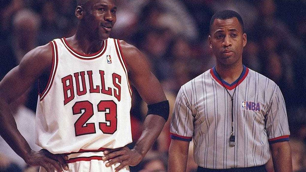 Guard Michael Jordan of the Chicago Bulls confers with an official during a game against the Atlanta Hawks at the United Center in Chicago, Illinois. The Bulls won the game, 97-90.