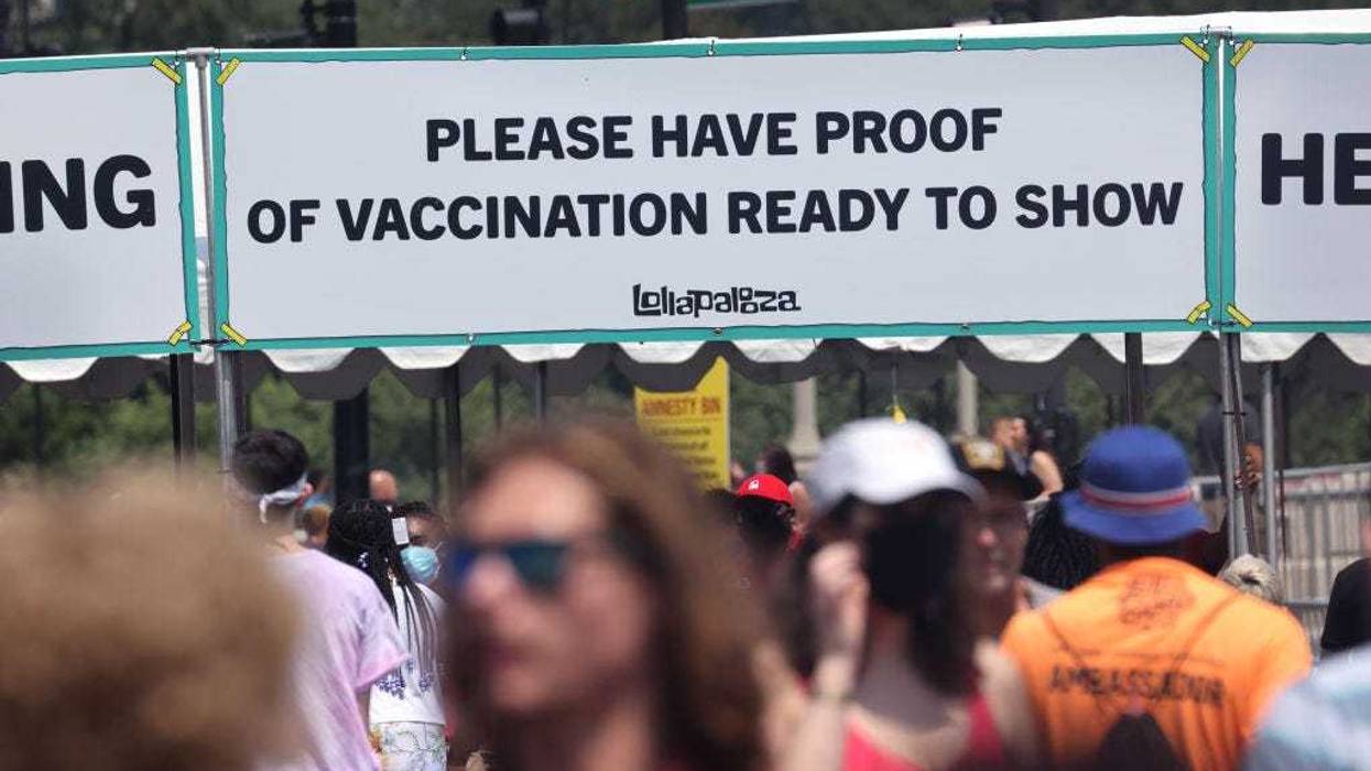 Guests are asked to show proof of having been vaccinated against the COVID-19 virus as they arrive for the first day of the Lollapalooza music festival on July 29, 2021 in Chicago, Illinois. The four-day music festival in the city's downtown is expected to draw 110,000 fans each day.