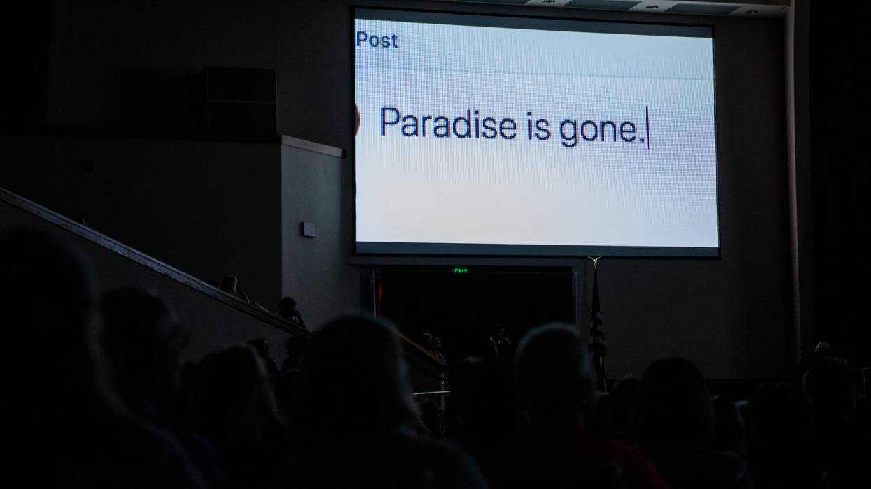 Guests watch a film play on projected screens during the Paradise Commemoration Ceremony at the Paradise Alliance Church on November 8, 2019 in Paradise, California.