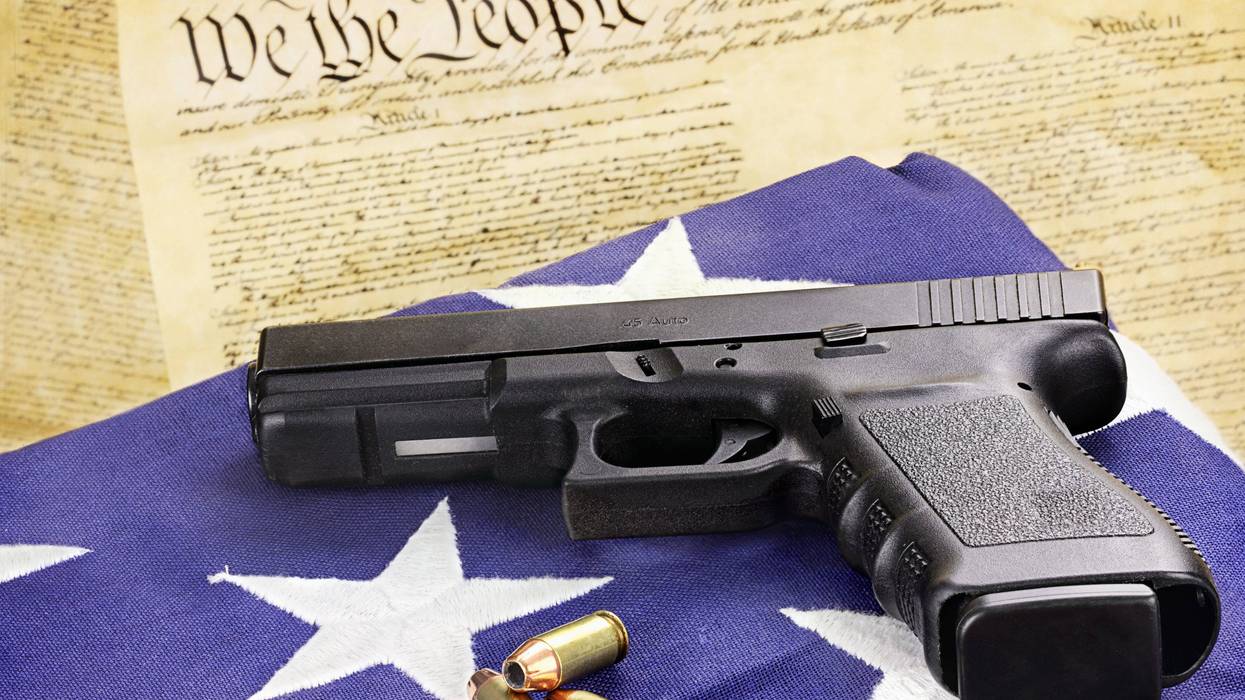 Gun and bullets on American flag and constitution