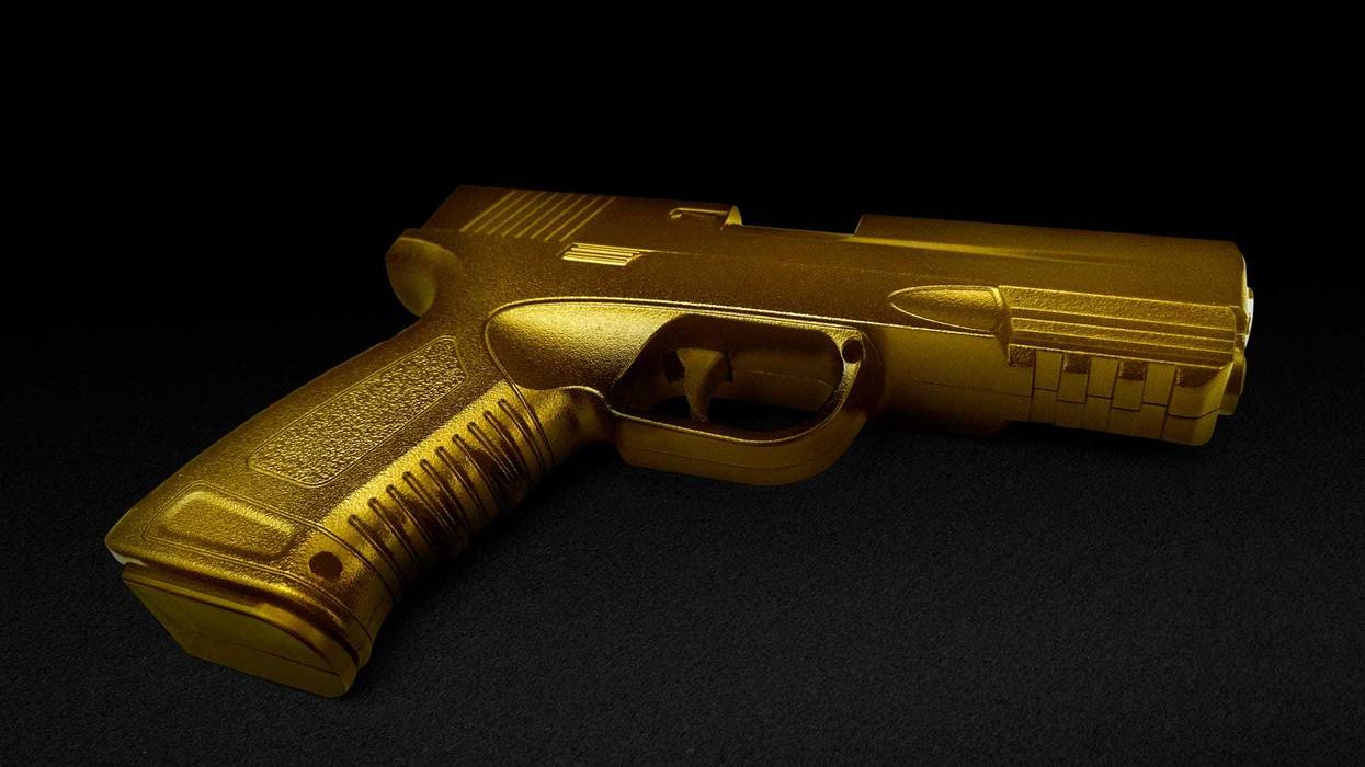 gun gold metal isolated on black background