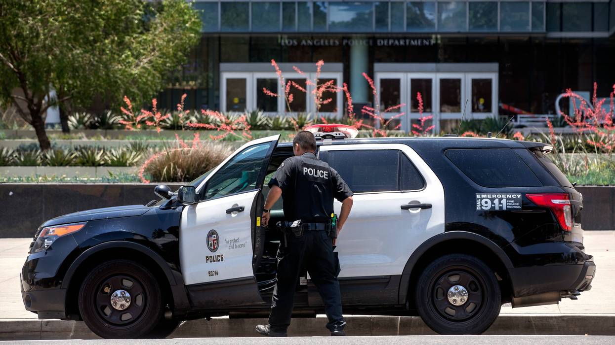 gun on tableA member of the LAPD gets into his patrol car parked in front of LAPD Headquarters on 1st St. in downtown Los Angeles.