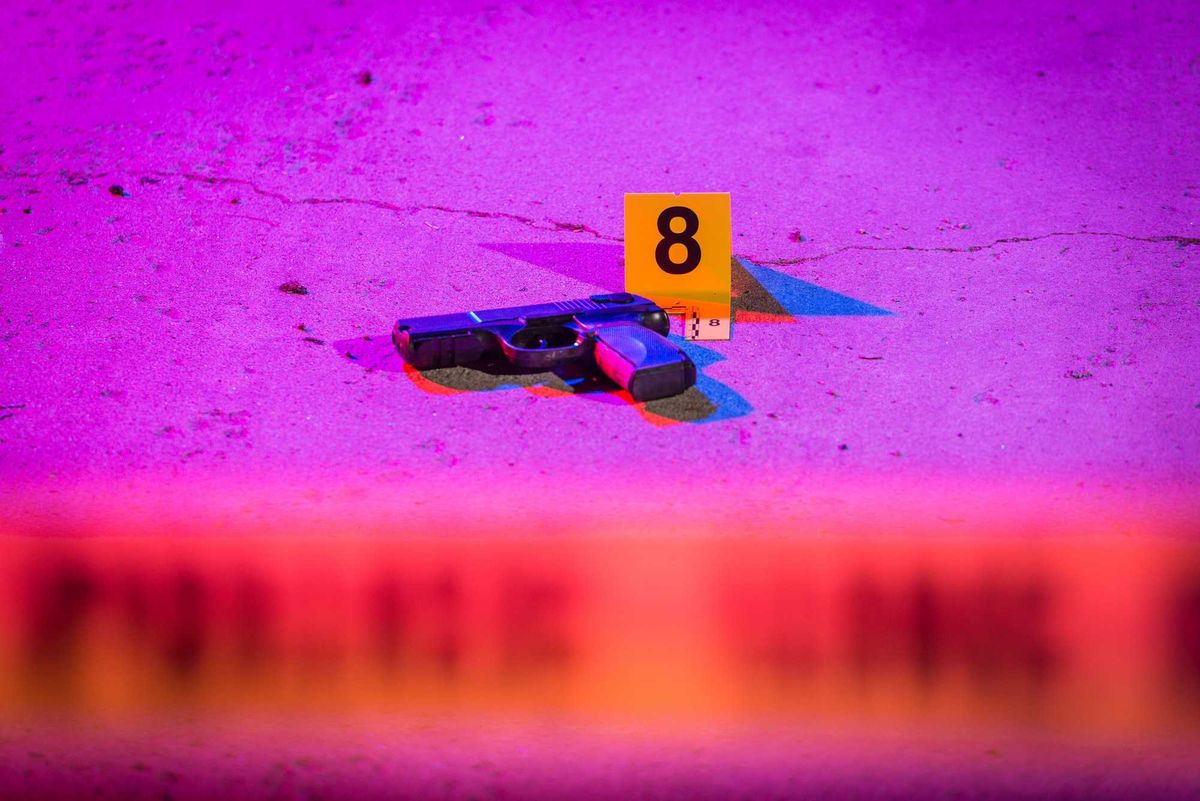 Gun on the ground at a crime scene.