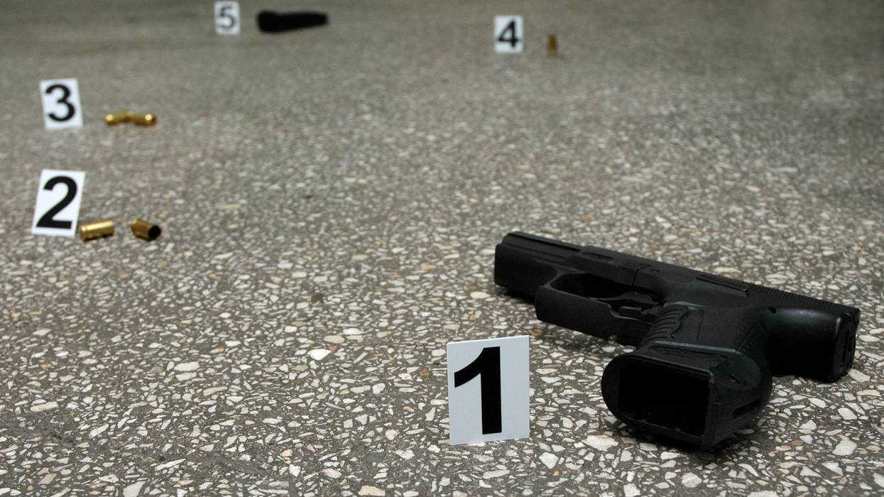 Guns and bullets on the floor with evidence markers.