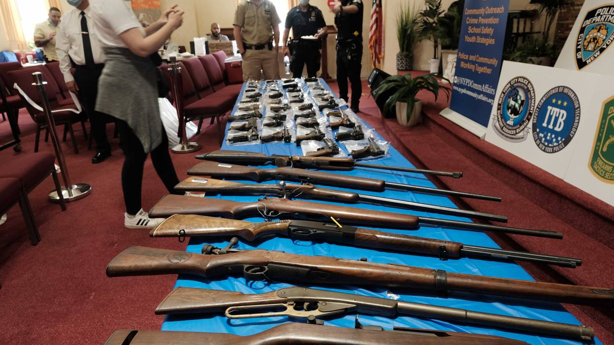 Guns are displayed on a table during a gun buy-back event at a church in Staten Island on April 24, 2021 in New York City. The one-day event, held at Calvary Chapel in Mariners Harbor, will pay a $200 pre-paid card to those who turn in an operable handgun or assault rifle, the department said. About 50 guns had been turned to the church by the early afternoon and no questions are asked to the origins of the weapon. The NYPD, the district attorney and others have organized the event as gun arrests have more than doubled so far this year on Staten Island. People can also receive a $25 pre-paid card for rifles, shotguns and airguns.