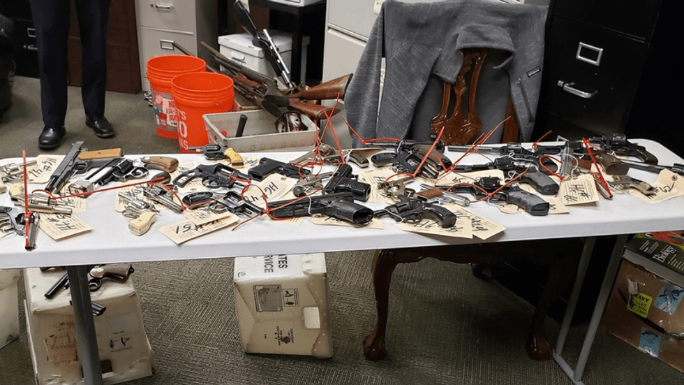 Guns are shown collected from a Philadelphia buyback event in January 2021.
