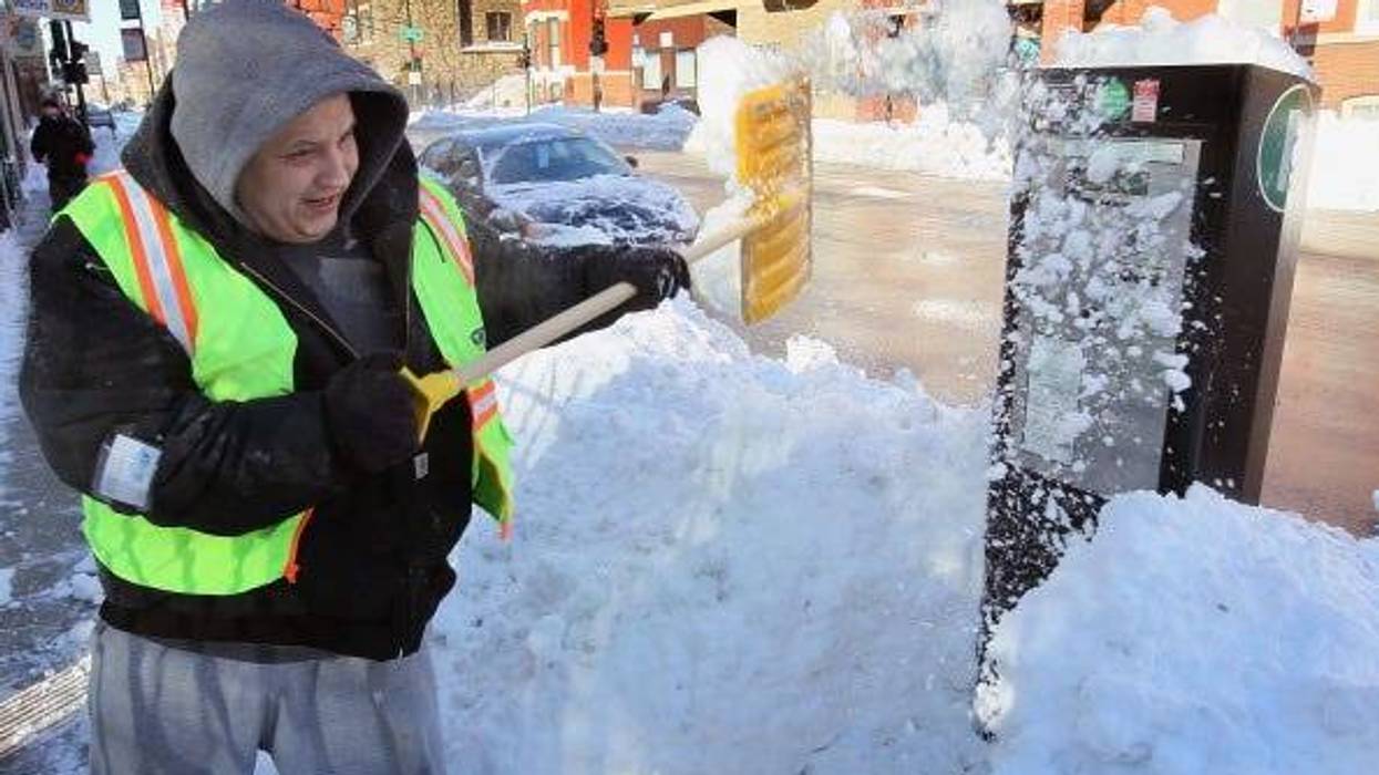 Gustavo Prieto clears snow from a parking meter February 3, 2011 in Chicago, Illinois. Throughout the city residents continue to dig out from more than 20 inches of snow that fell on the area Tuesday and Wednesday. (Photo by Scott Olson/Getty Images)