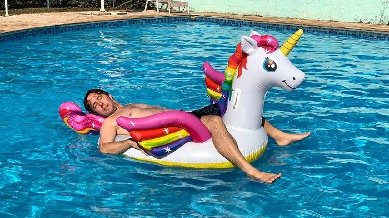 Guy floating in pool