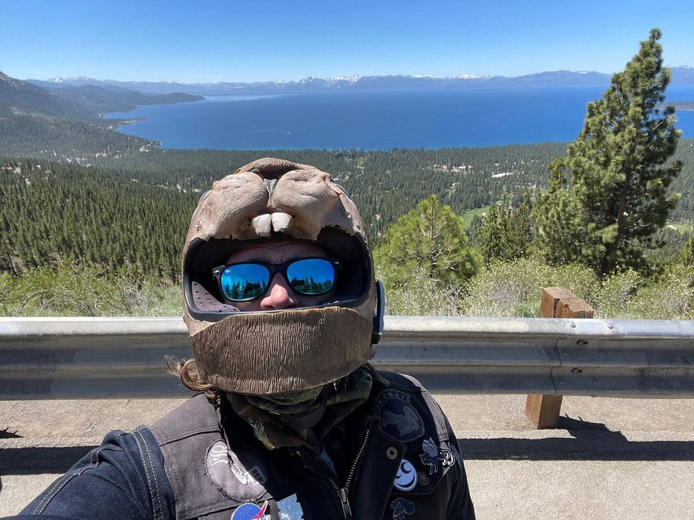 guy in a dumb helmet in front of water