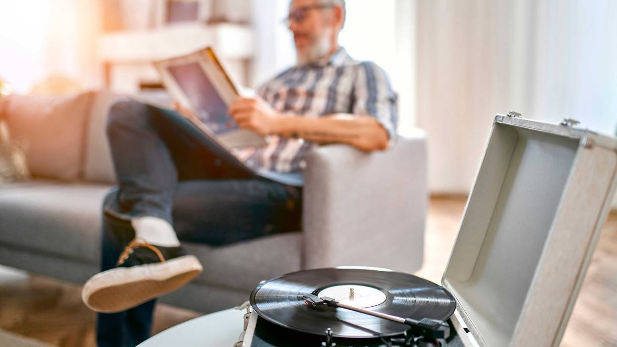 guy listening to music on a record player