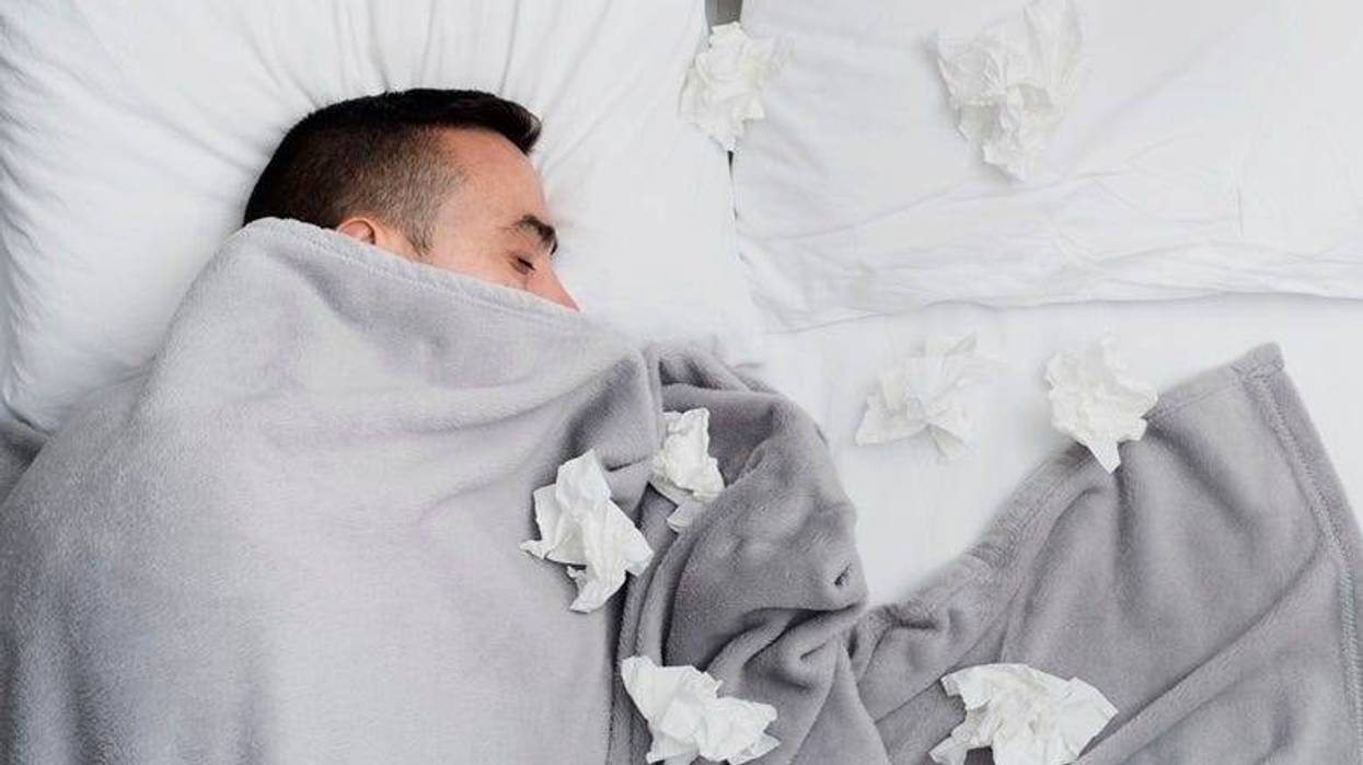 Guy sick in bed