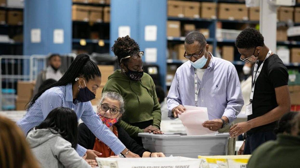 Gwinnett County election workers look over absentee and provisional ballots at the Gwinnett Voter Registrations and Elections office on November 6, 2020 in Lawrenceville, Georgia.