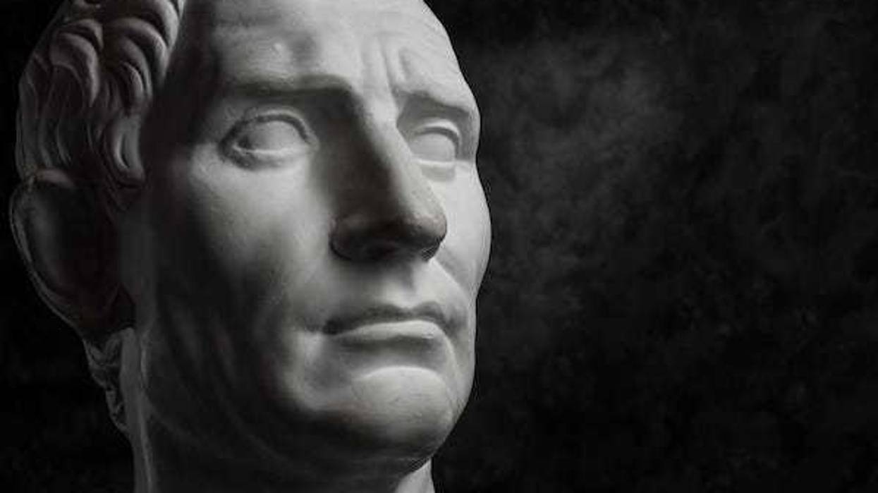 Gypsum copy of ancient statue Augustus head on dark textured background