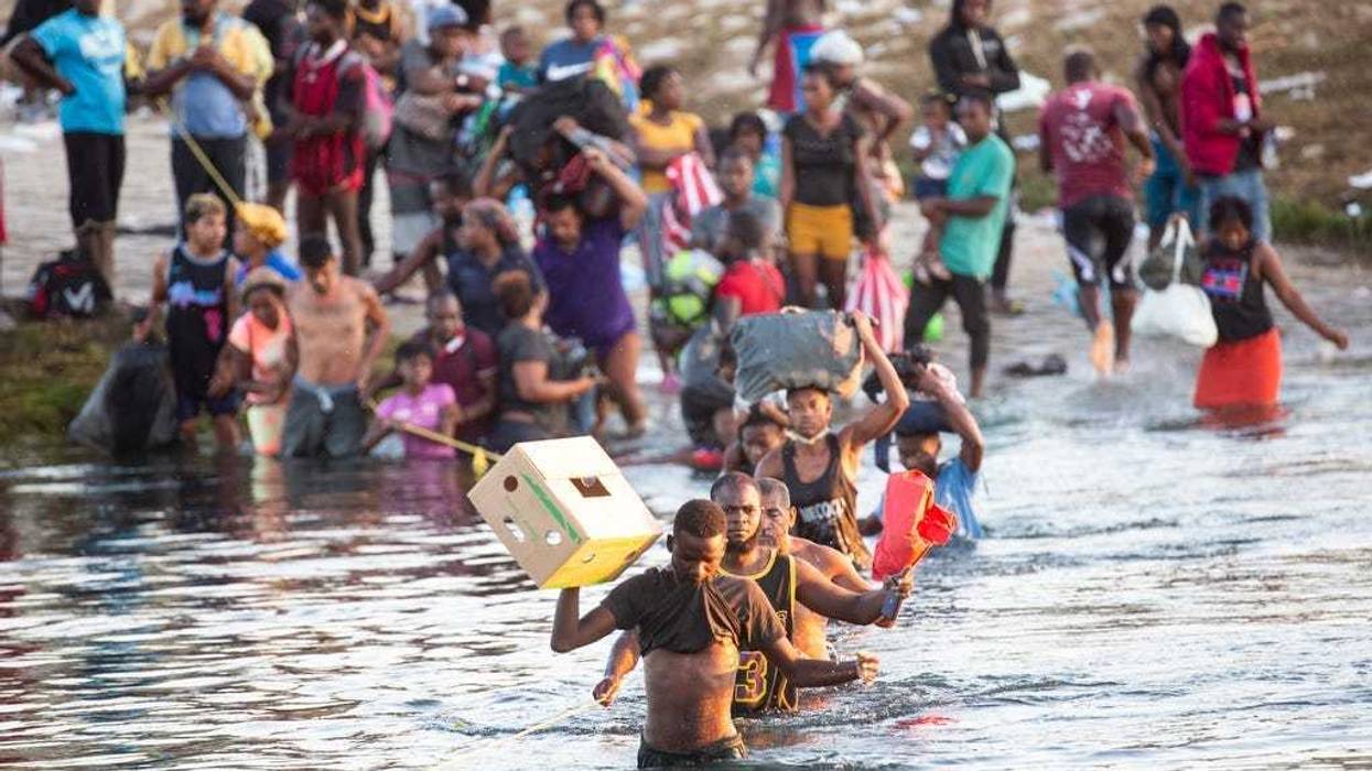 Haitian migrants cross the Rio Grande