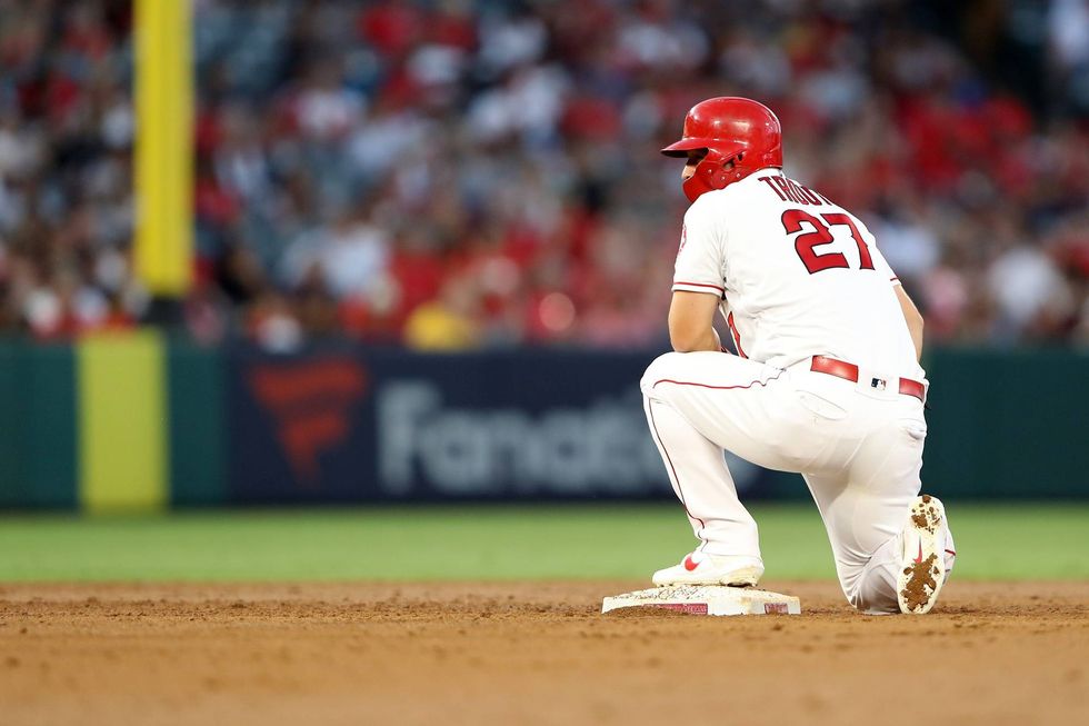 Halos outfielder Mike Trout takes a knee at second base