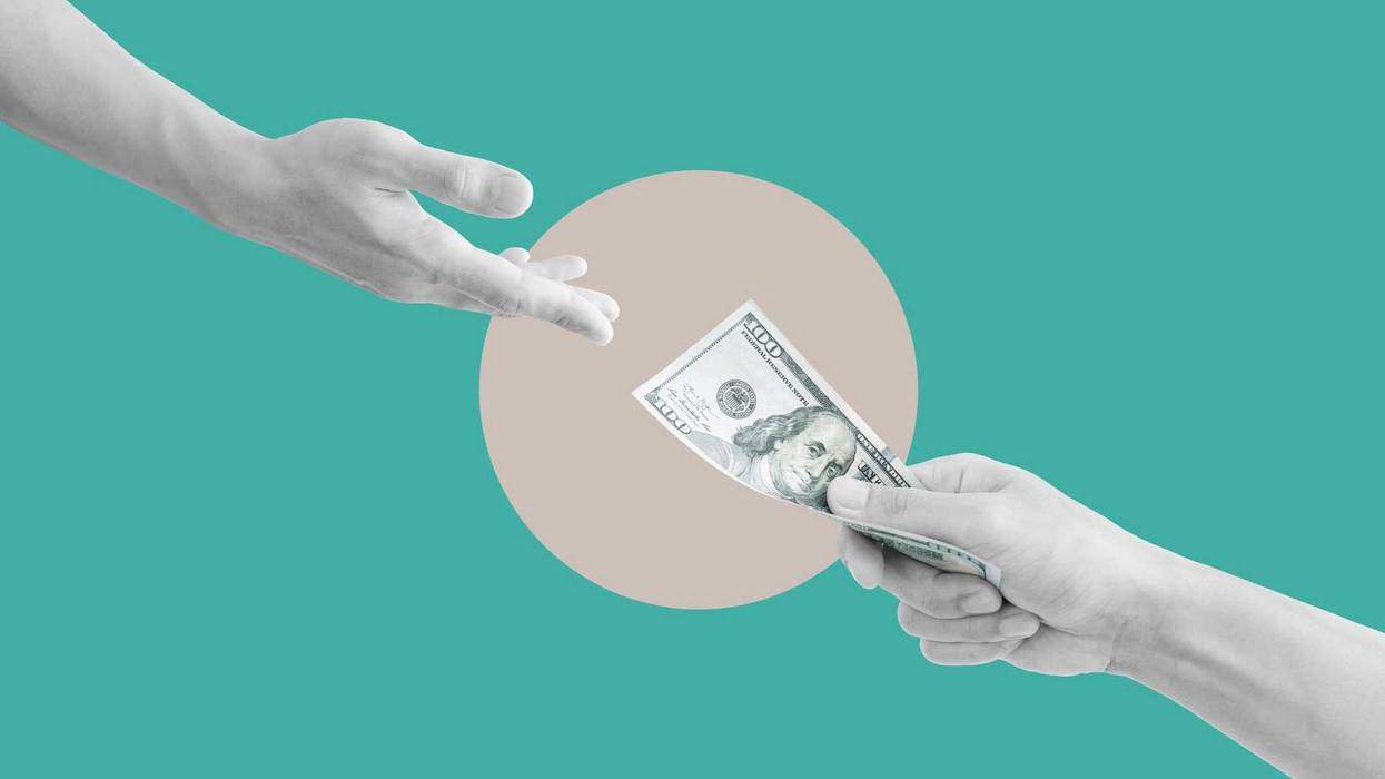 Hand giving moeny stock image.