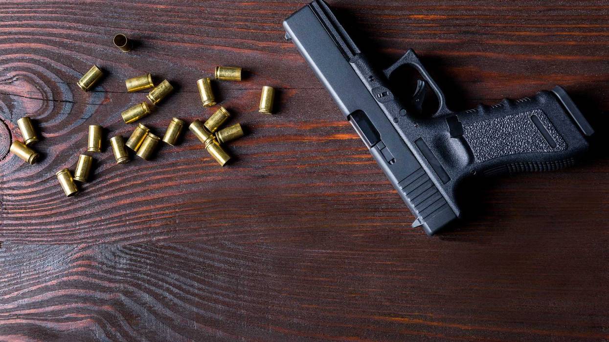 Hand gun and empty bullet casings.