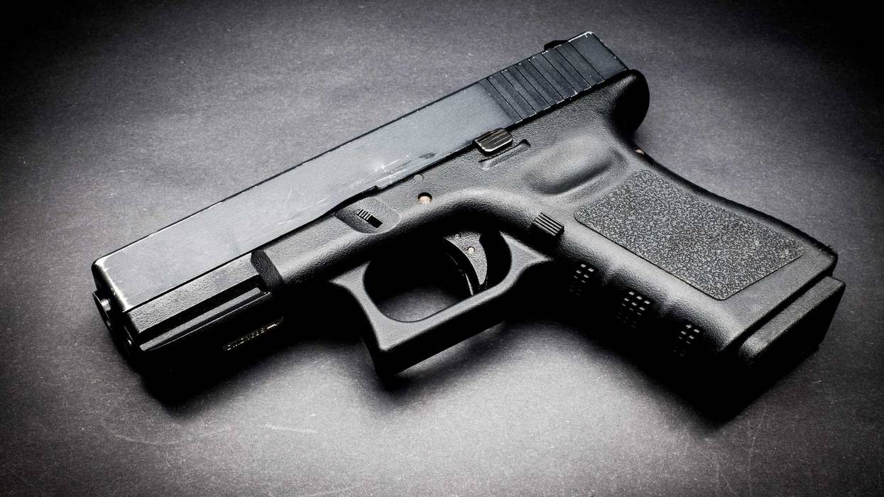 Hand gun on black background