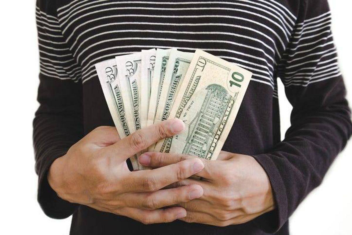 Hand holding cash, isolated on white background