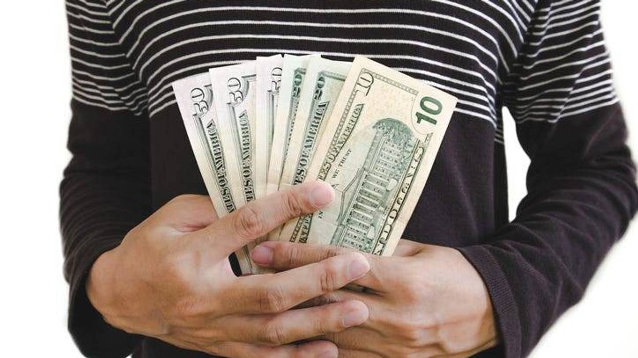 Hand holding cash, isolated on white background