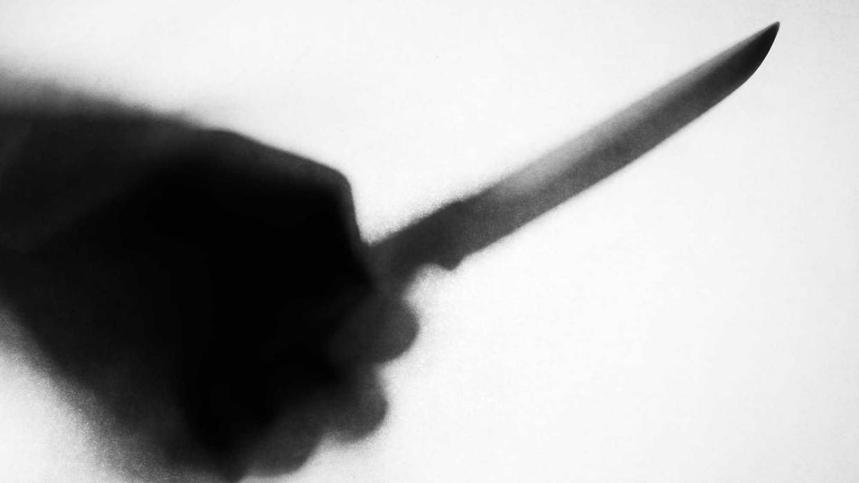 Hand holding knife stock photo.