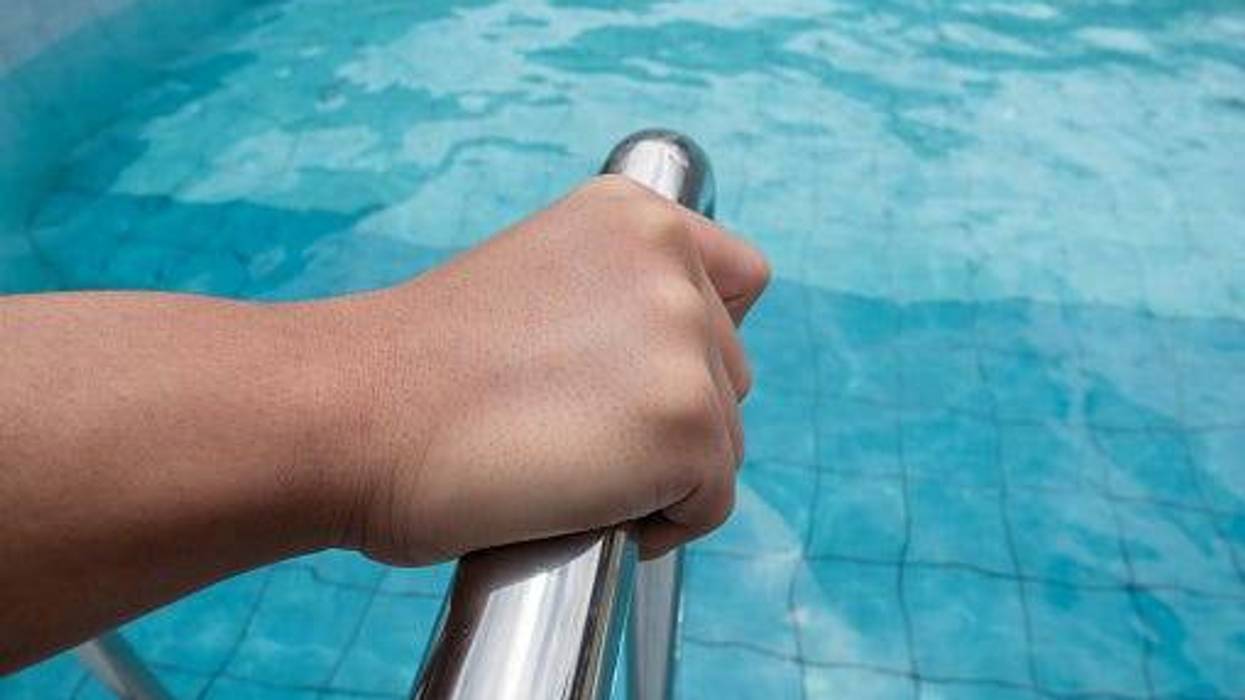 Hand on pool rail