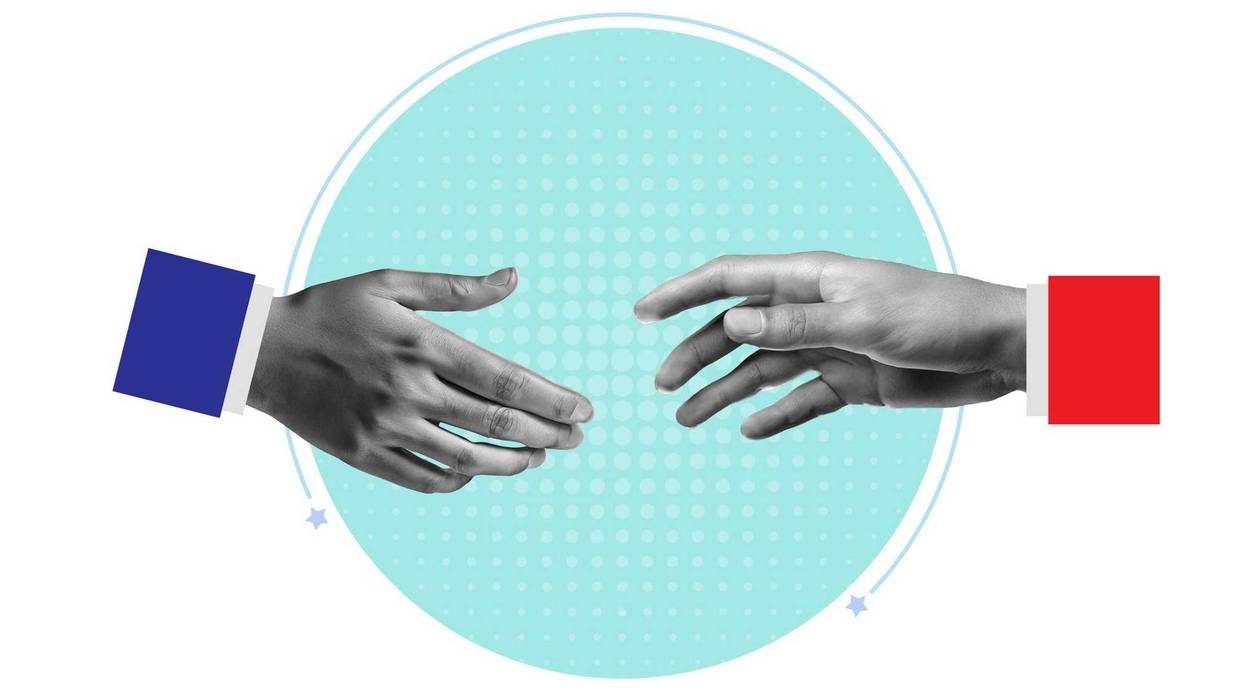 hand with blue sleeve and hand with red sleeve reaching to touch