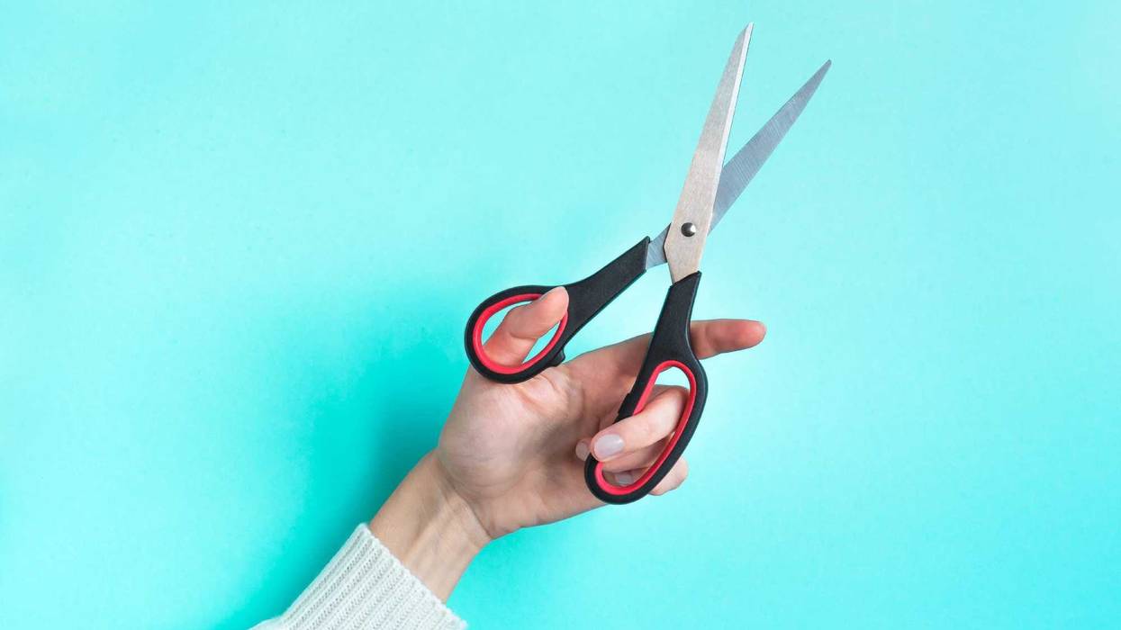 Hand with scissors stock photo.