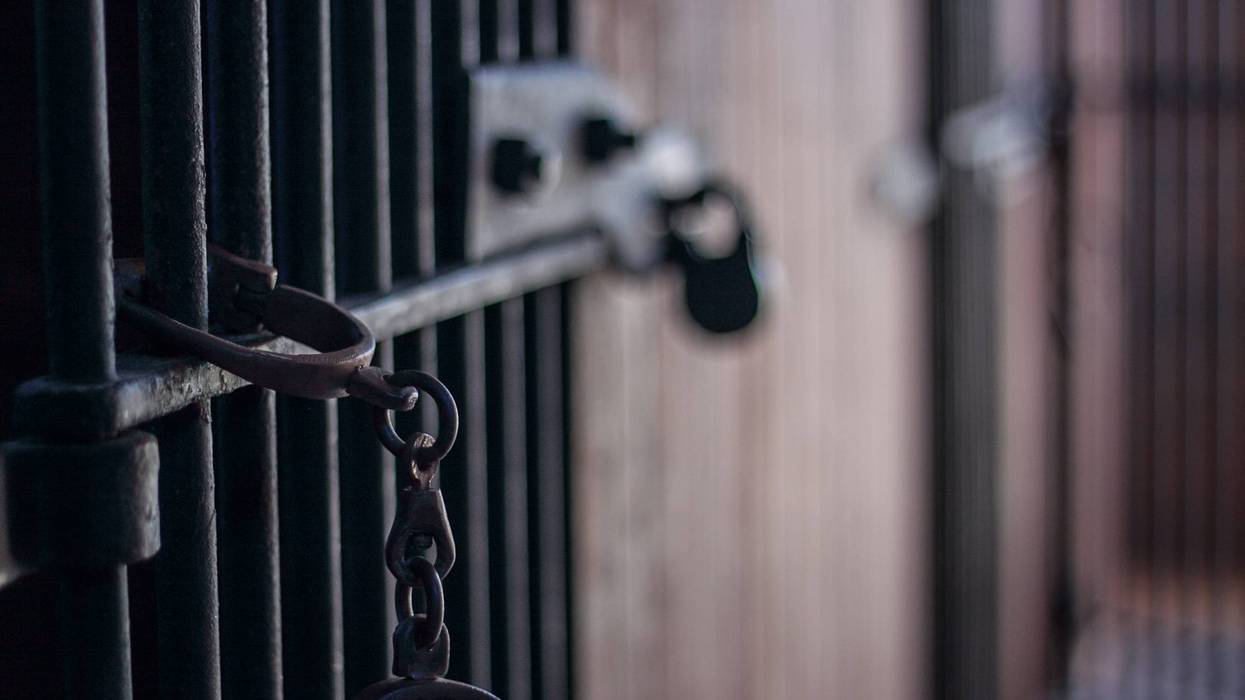 Handcuffs in abandoned jail with bars