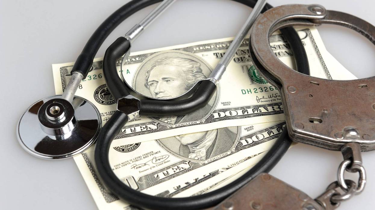 handcuffs, stethoscope, and money
