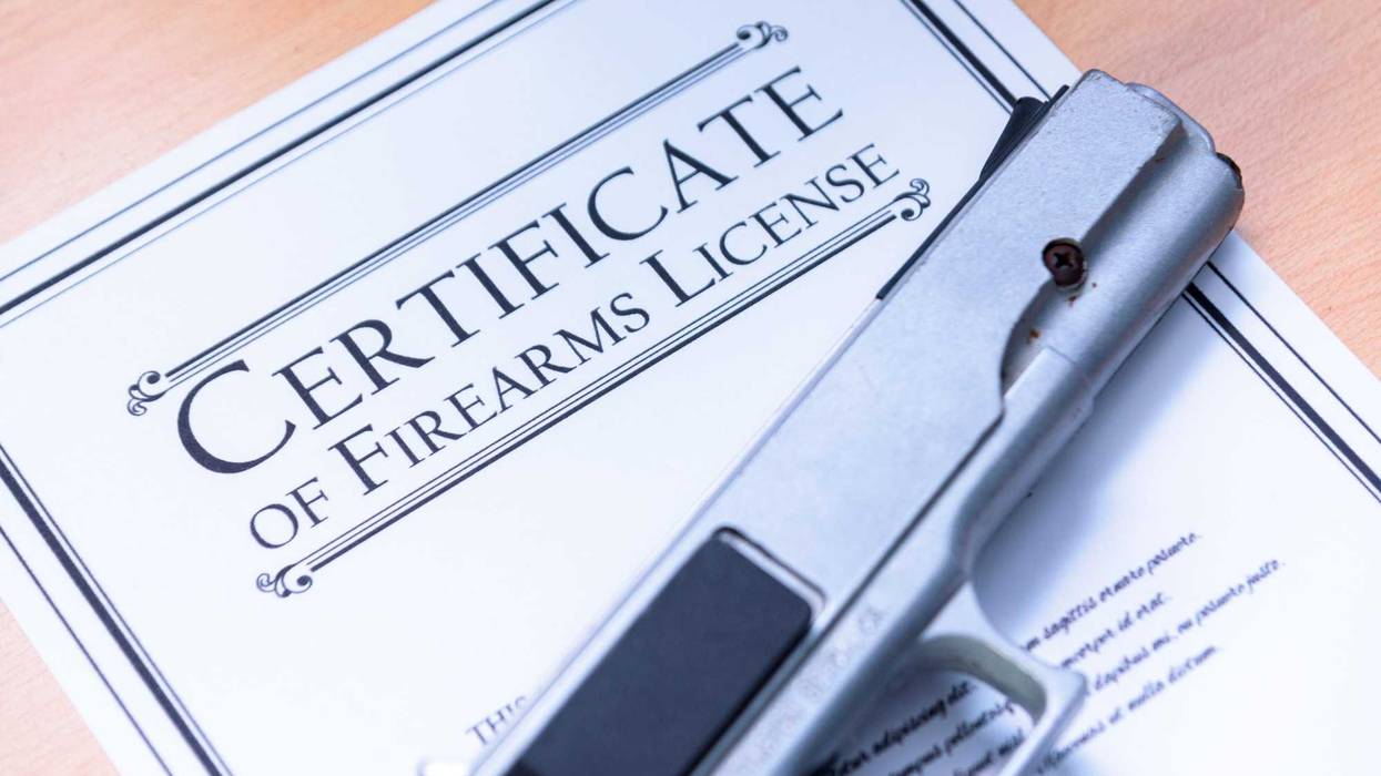 Handgun laying on a Gun / Firearms License Certificate
