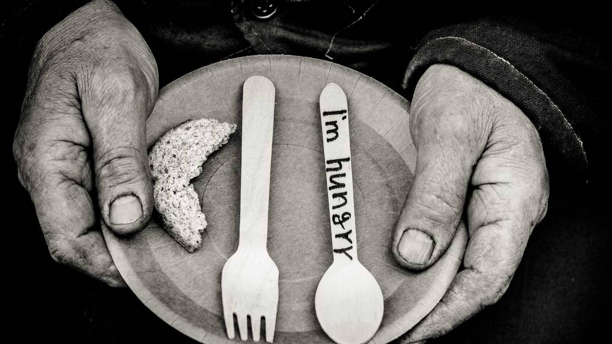 hands holding a plate with "I'm hungry" written on a spoon