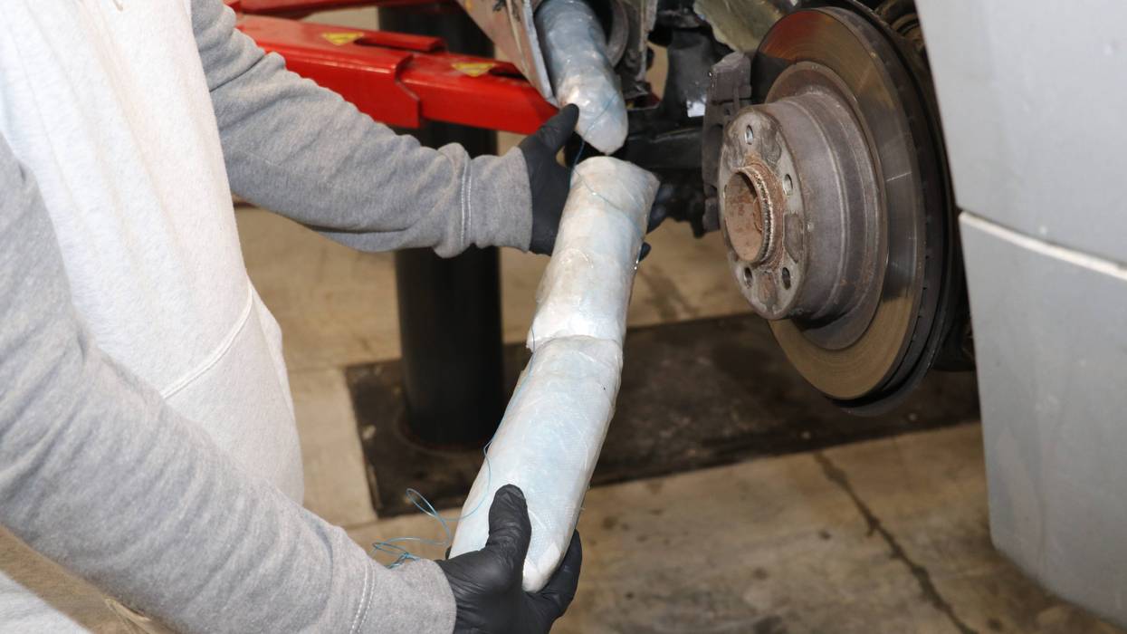 Hands holding rolls of powder fentanyl