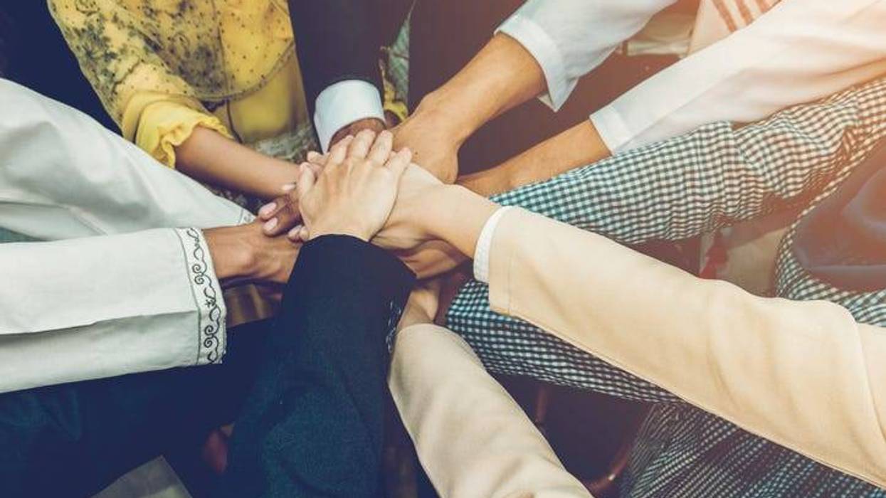 hands joining together to help