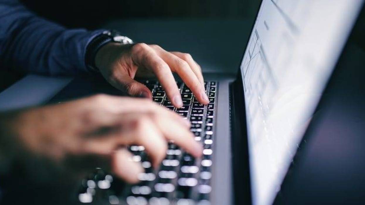 hands typing on laptop