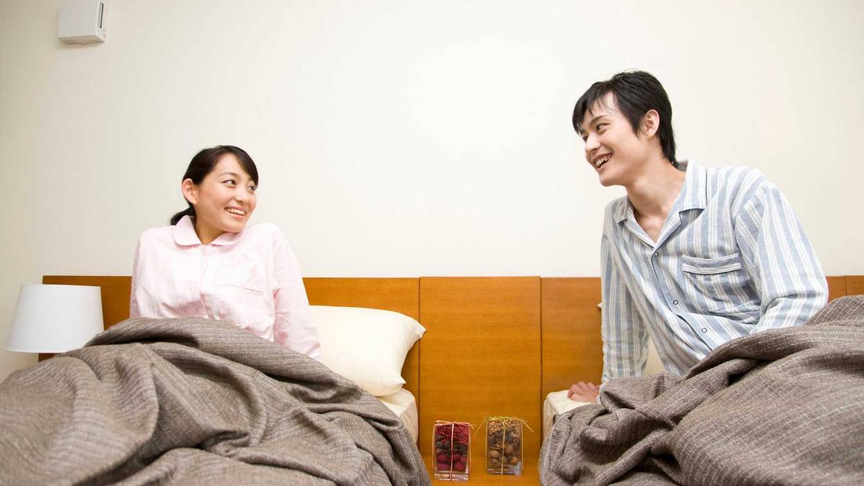 Happy couple in separate beds