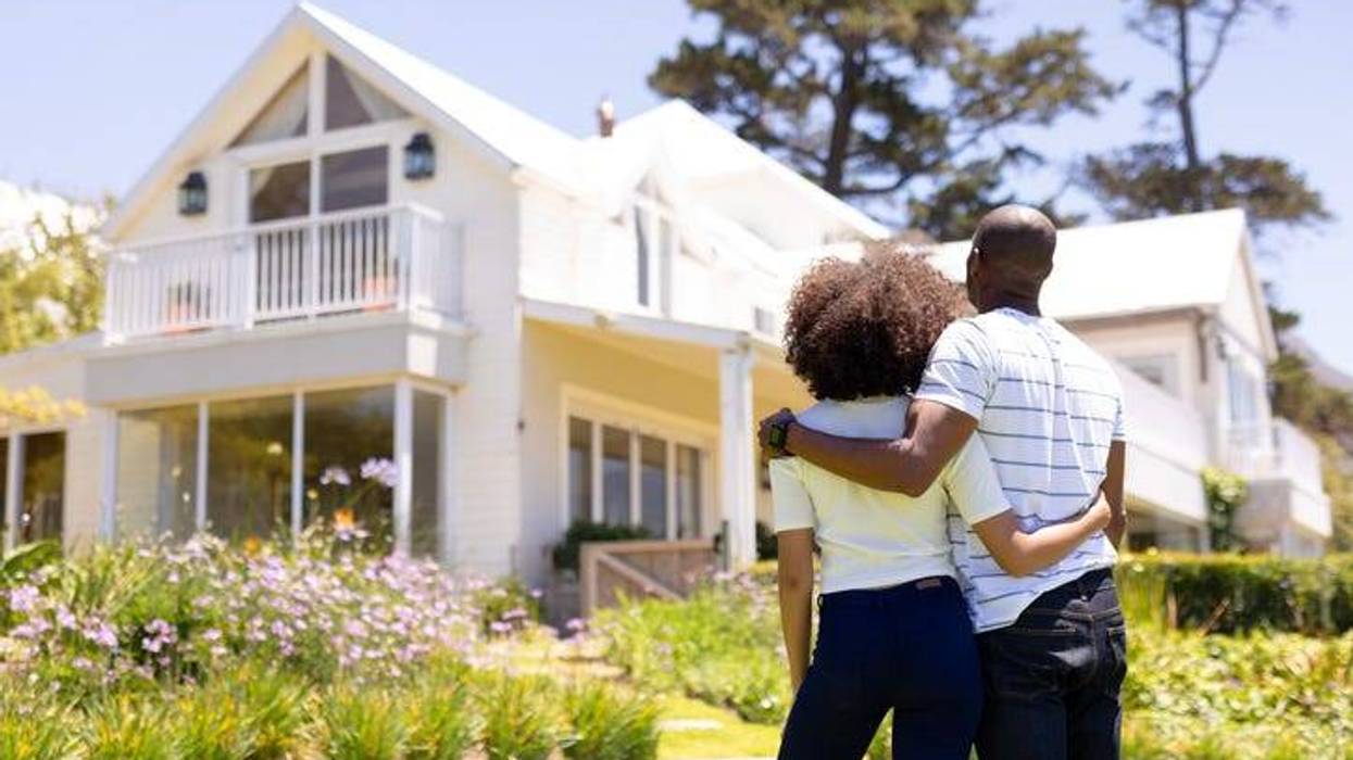 Happy Couple Outside Of Their House