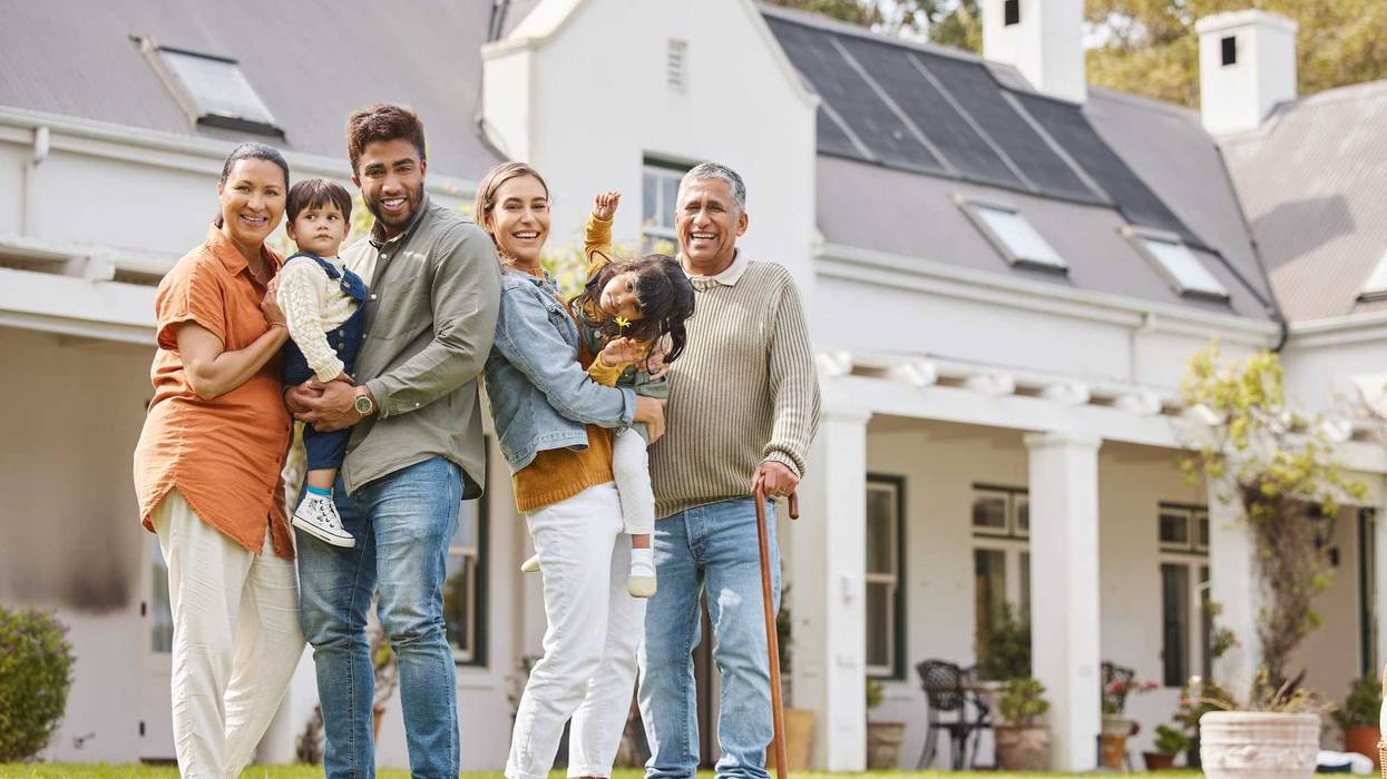 Happy family on the yard in front of their house