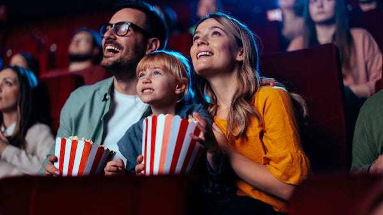 Happy family watching a movie in the theater