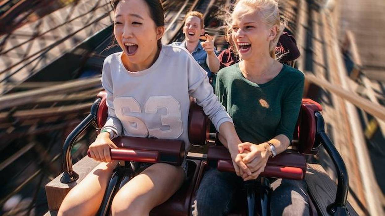Happy friends riding a roller coaster