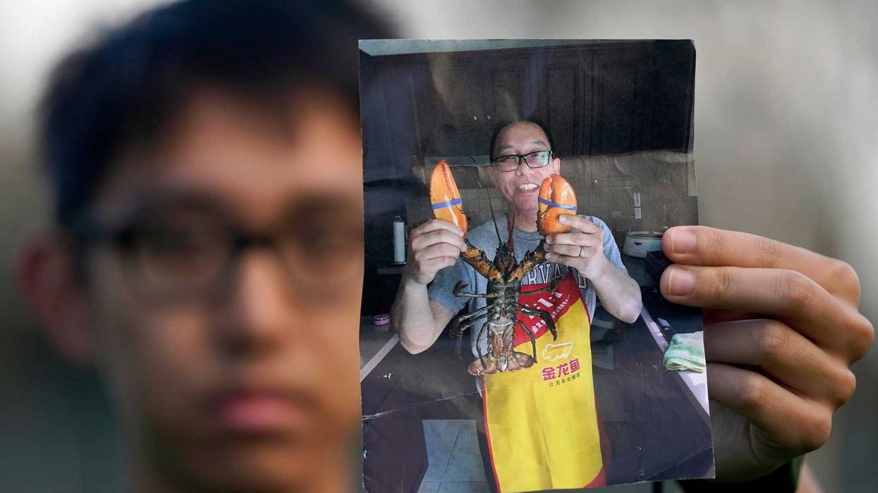 Harrison Li holds a photo of his father, Kai Li, as he poses for a photo, Jan. 23, 2024, in Palo Alto, Calif