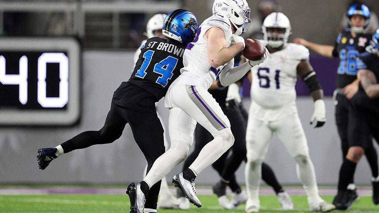 Harrison Smith #22 of the Minnesota Vikings intercepts a pass intended for Amon-Ra St. Brown #14 of the Detroit Lions during the third quarter at U.S. Bank Stadium on December 25, 2025 in Minneapolis, Minnesota.
