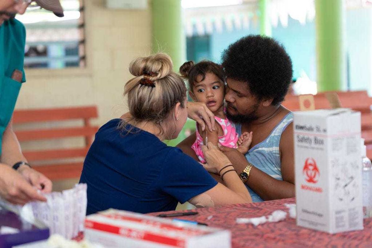 Hawaii aid workers (nurses) help out with MMR vaccinations on December 6, 2019 in Apia, Samoa.