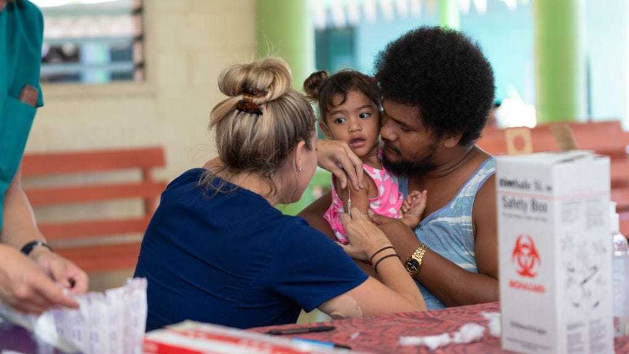 Hawaii aid workers (nurses) help out with MMR vaccinations on December 6, 2019 in Apia, Samoa.