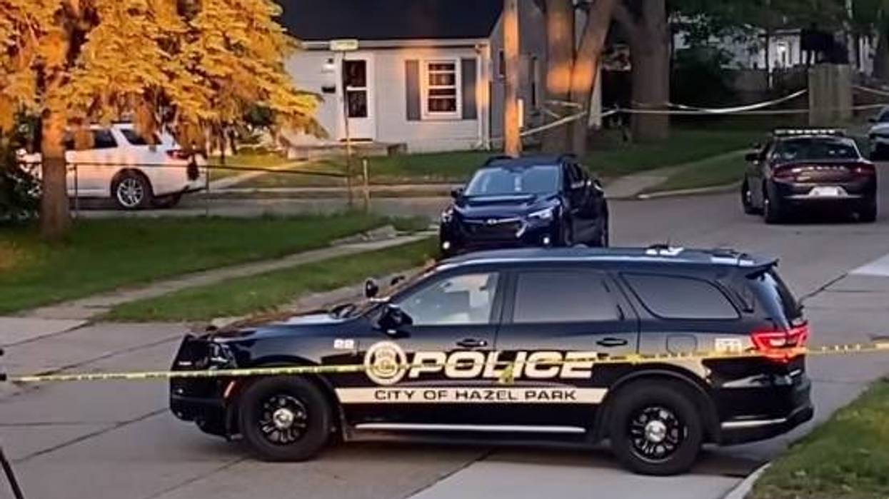Hazel Park Police SUV blocking a residential street with yellow crime scene tape.