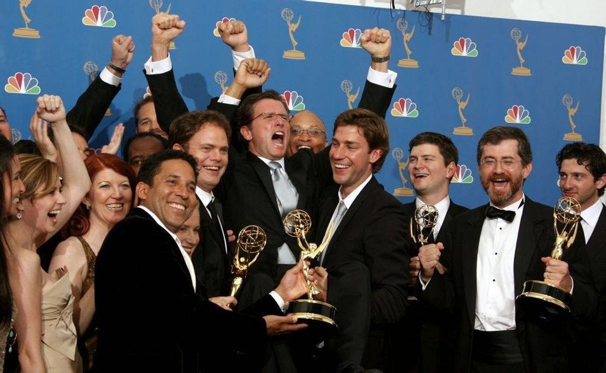 he cast of "The Office" raises President of NBC Entertainment Kevin Reilly (C) in the press room at the 58th Annual Primetime Emmy Awards at the Shrine Auditorium on August 27, 2006 in Los Angeles, California.