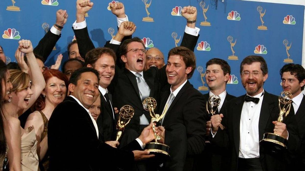 he cast of "The Office" raises President of NBC Entertainment Kevin Reilly (C) in the press room at the 58th Annual Primetime Emmy Awards at the Shrine Auditorium on August 27, 2006 in Los Angeles, California.
